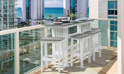 EC Woods Belmar Outdoor Poly Bar Height Furniture Set shown in Coastal Gray and Bright White on Balcony