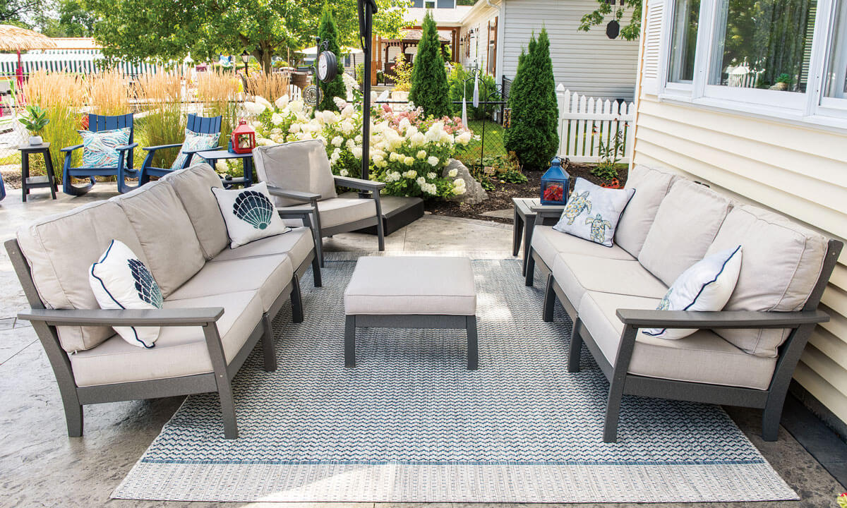 EC Woods Calistoga Outdoor Poly Furniture Set Shown in Dark Gray with Sunbrella Natural Cushions